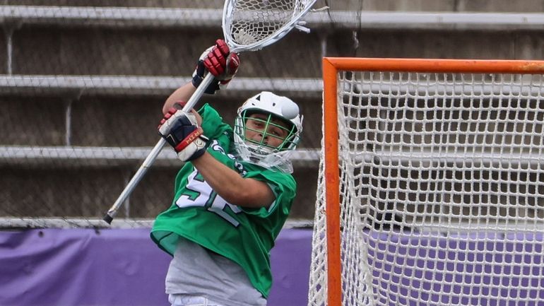 Farmingdale goalkeeper Mike Ippoliti goes up for a shot on...