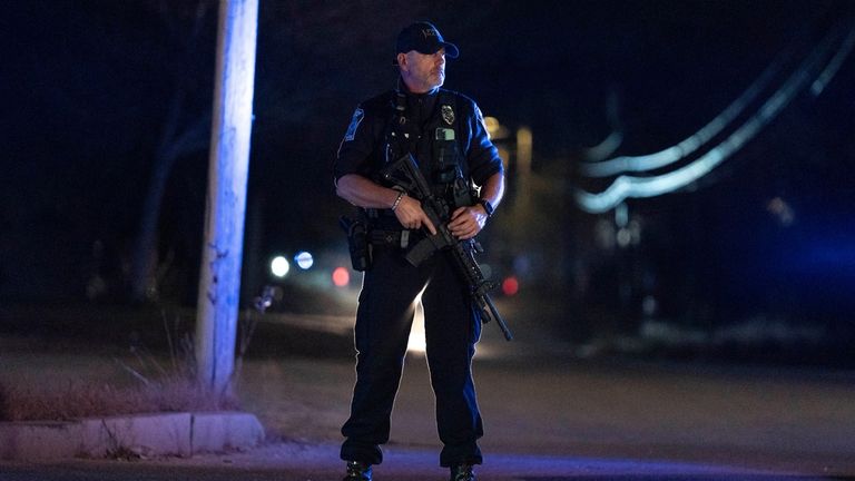 A police officer guards the road to a recycling facility...