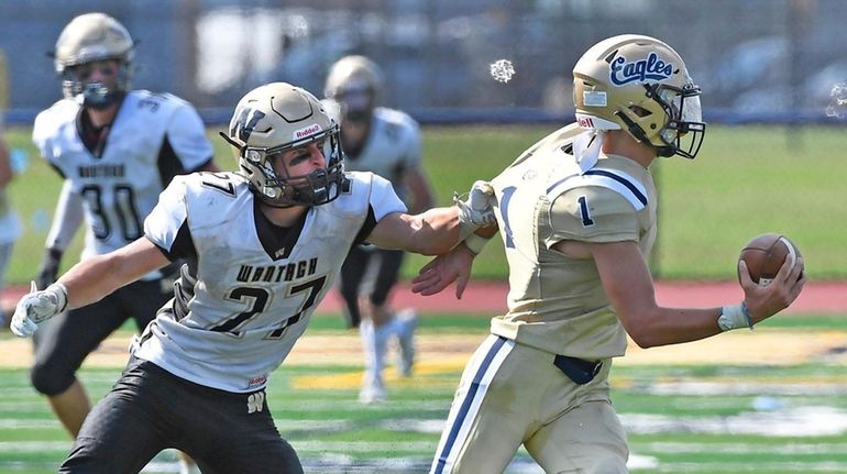 Tyler Martini of Wantagh gets a grip on Bethpage QB Luke...