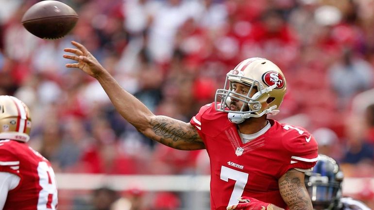 Quarterback Colin Kaepernick #7 of the San Francisco 49ers attempts...