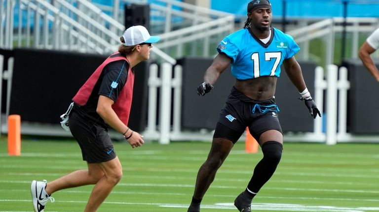 Carolina Panthers wide receiver Xavier Legette (17) runs a drill...