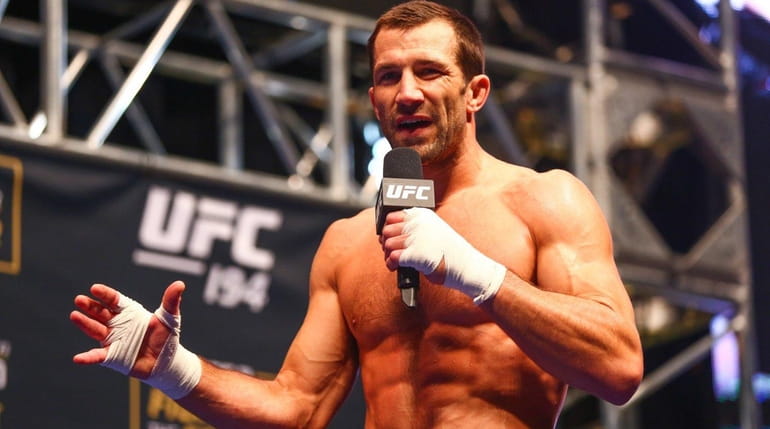Luke Rockhold answers questions from media at an open workout...