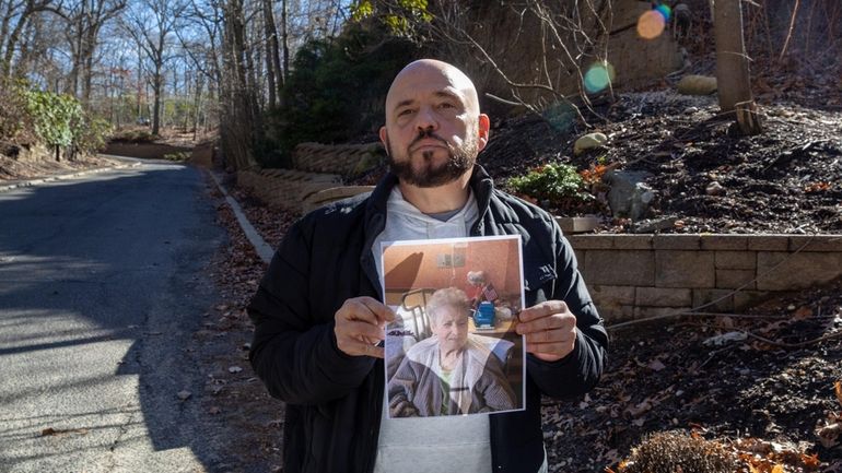 Randy Stewart holds a photo of his mother, Rosemary Stewart,...