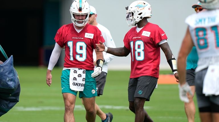 Miami Dolphins quarterbacks Skylar Thompson (19) and Tyler Huntley (18)...