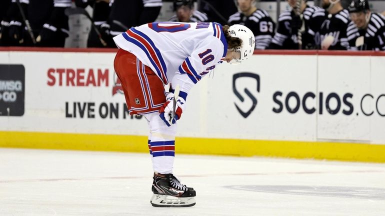 Rangers left wing Artemi Panarin reacts as he skates past...