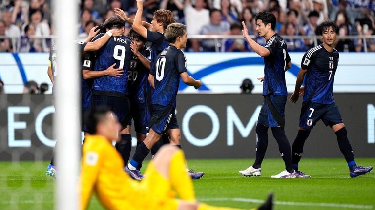 Japan's players celebrate Japan's fourth goal during a World Cup...