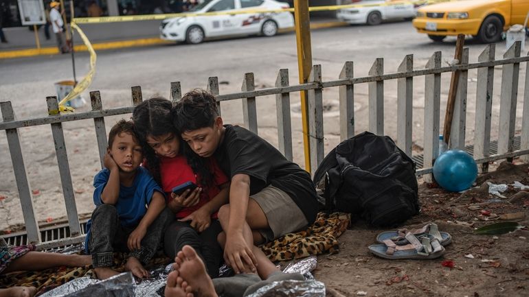 The Bolaños children, from left, Sebastian, Kamila and Miguel Angel,...