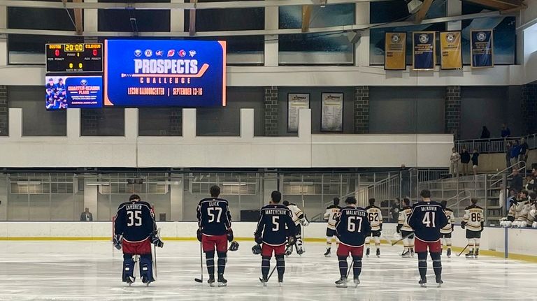 Columbus Blue Jackets line up at their blue line for...