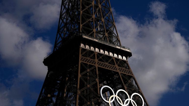 The Olympic rings are seen on the Eiffel Tower during...