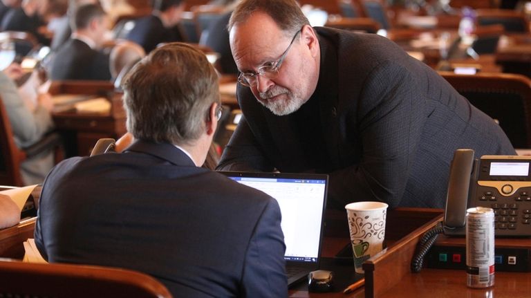 Kansas state Rep. Tobias Schlingensiepen, left, D-Topeka, confers with Rep....