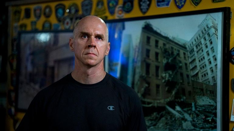 Mike Keane, owner of O'Hara's pub and surrounded by patches...