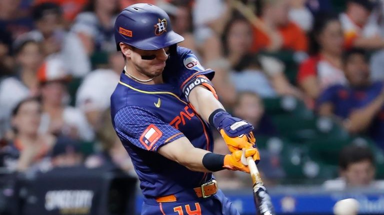 Houston Astros' Mauricio Dubon connects for a one-run RBI single...