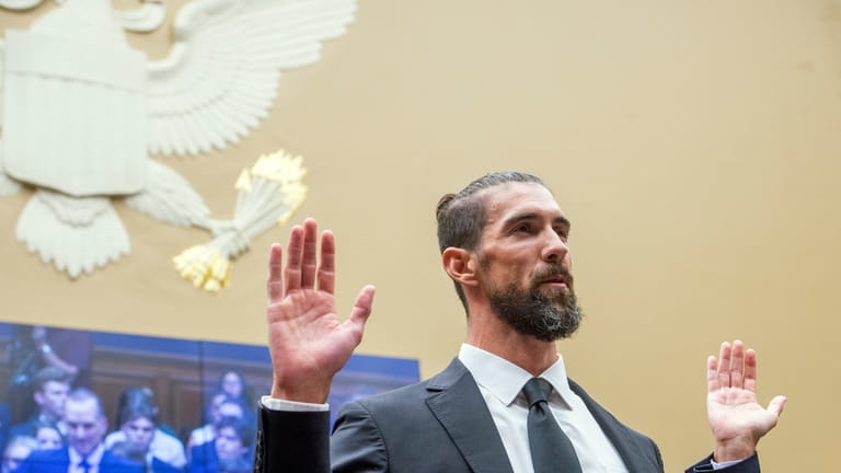 Michael Phelps, former Olympic athlete is sworn in during a...