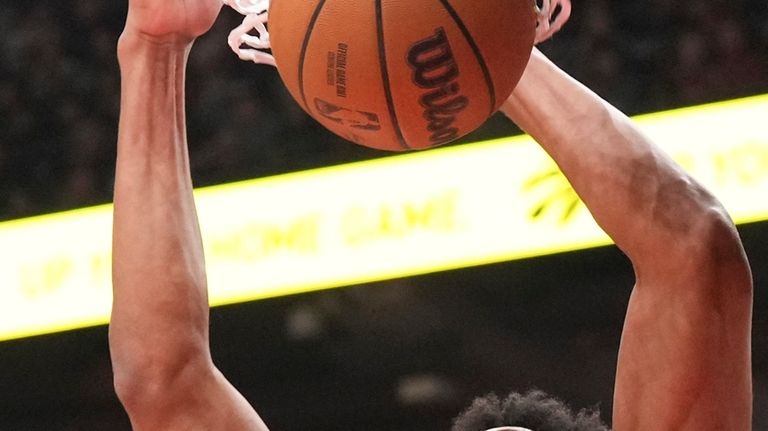 Toronto Raptors' Scottie Barnes dunks against the Dallas Mavericks during...