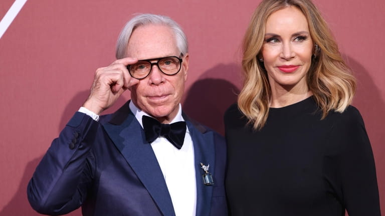 Tommy Hilfiger, left, and Dee Ocleppo pose for photographers upon...