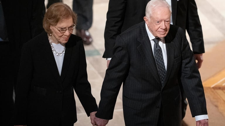 Former President Jimmy Carter, right, and his wife, former first...