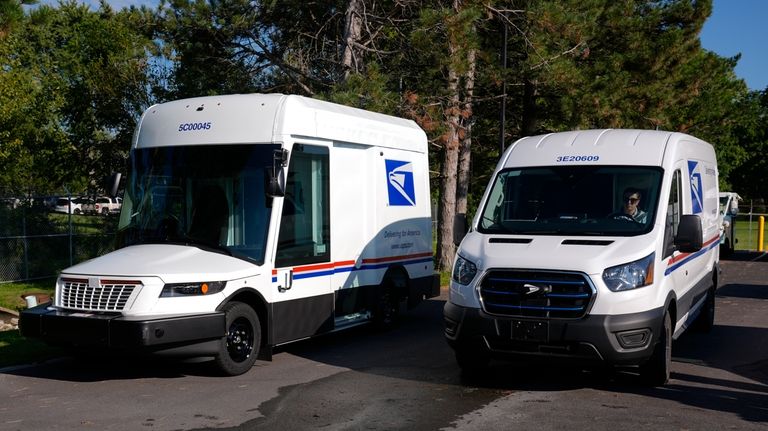 The U.S. Postal Service's next-generation delivery vehicle, left, is displayed...