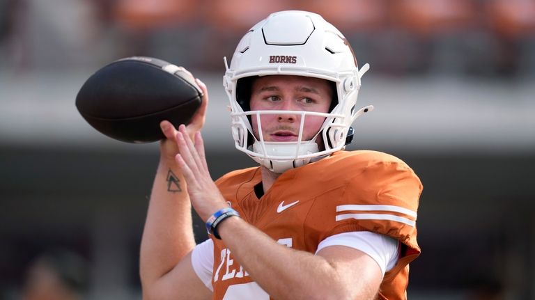 Texas quarterback Quinn Ewers (3) throws before an NCAA college...