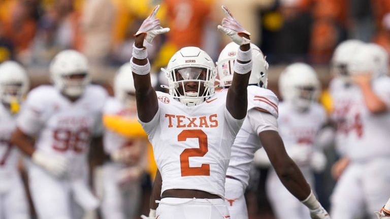 Texas defensive back Derek Williams Jr. (2) celebrates a Michigan...