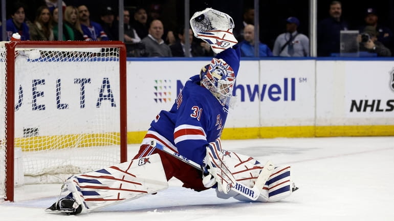 Igor Shesterkin of the Rangers makes a glove save late during...