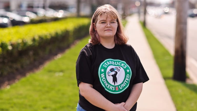 Starbucks employee Ashley Larsen, of Westbury, 19, stands outside the...