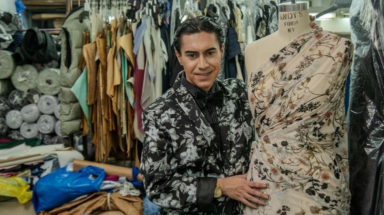 Evan Hirsch shows off a floral dress he designed at...