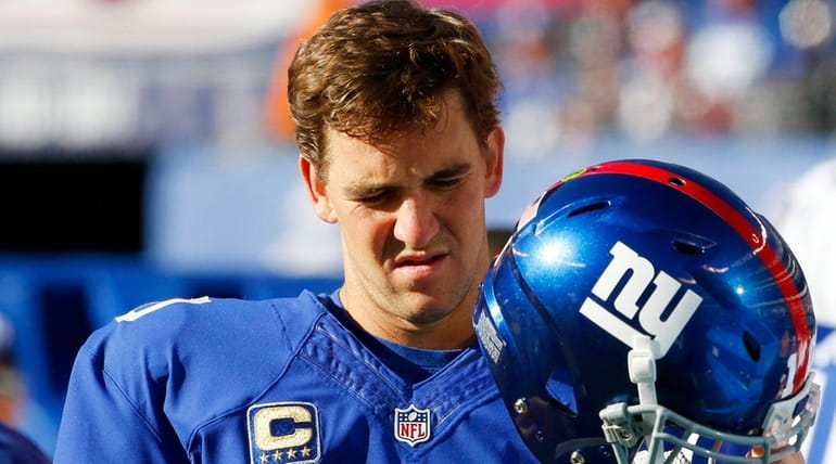 Eli Manning of the New York Giants looks on from...