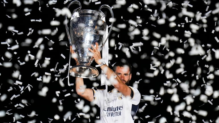 Real Madrid's Nacho holds the Champions League trophy at the...