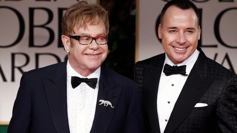 Elton John, left, and David Furnish arrive at the 69th...