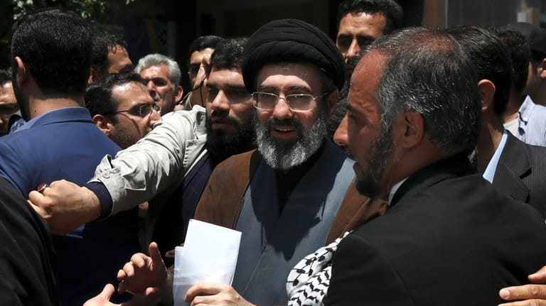 Mojtaba, son of Iranian Supreme Leader Ayatollah Ali Khamenei, center,...