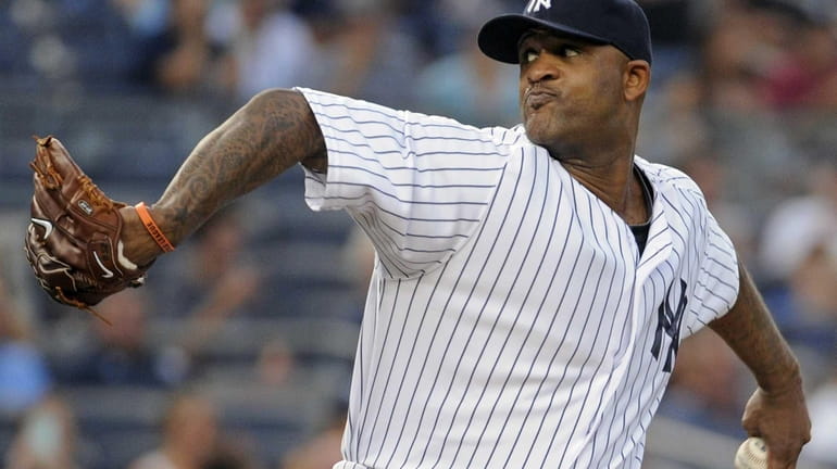 Yankees pitcher CC Sabathia delivers the ball to the Baltimore...