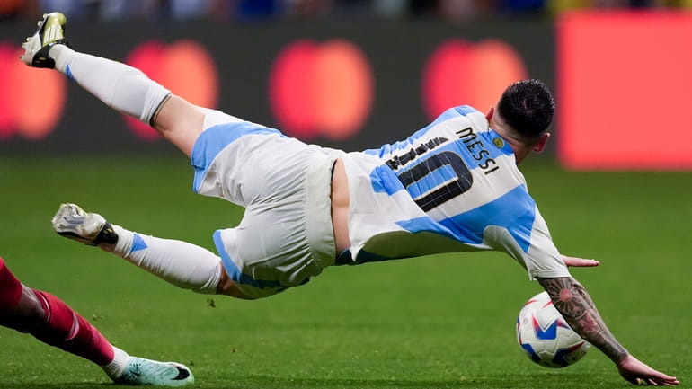 Argentina's Lionel Messi falls during a Copa America Group A...