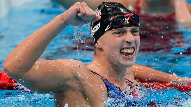 Katie Ledecky, of the United States, celebrates after winning the...