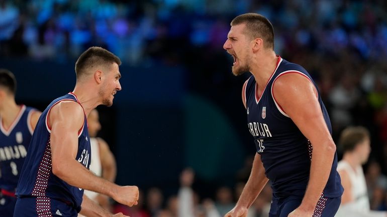 Nikola Jokic (15), of Serbia celebrates a basket against Germany...