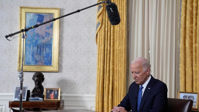 President Joe Biden pauses before he addresses the nation from...