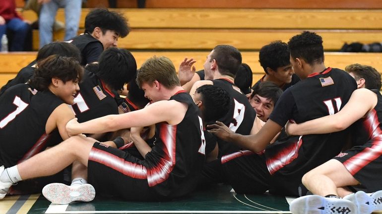 Syosset teammates celebrate after their win over East Meadow in...