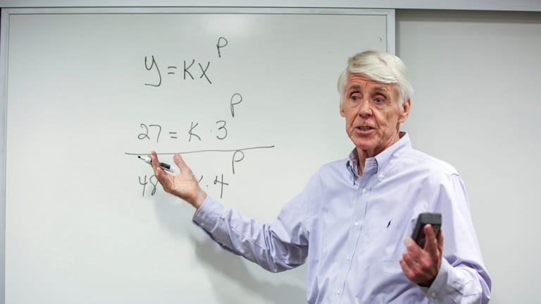 Teacher Jerry Howland explains an equation during the Bridge to...