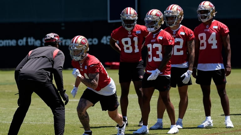 San Francisco 49ers wide receiver Ricky Pearsall, second from left,...