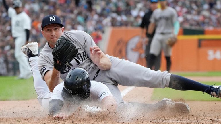 New York Yankees pitcher Tim Mayza tags out Detroit Tigers'...