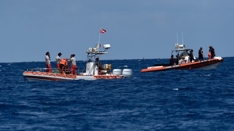 Scuba divers of the Italian Firefighters corp at the scene...