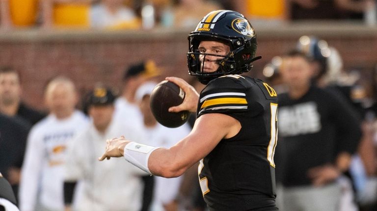 Missouri quarterback Brady Cook throws a pass during the first...