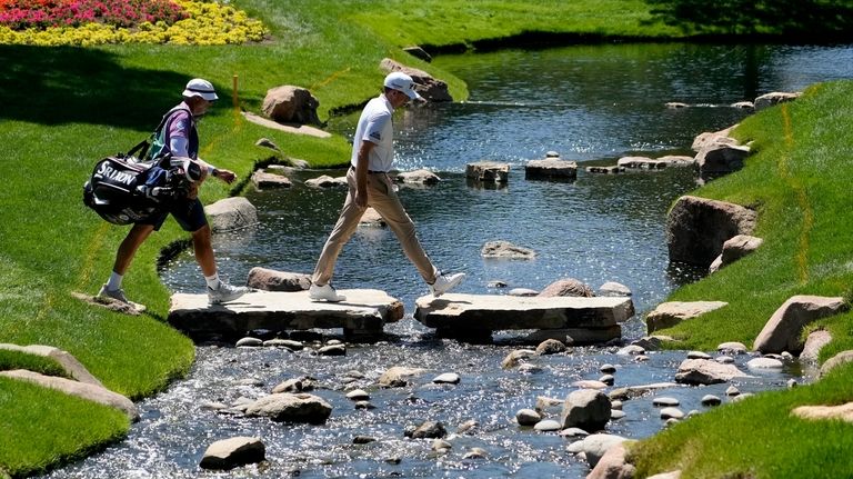 Keegan Bradley walks to the 14th green during the first...