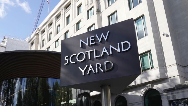 A sign stands in front of the New Scotland Yard,...