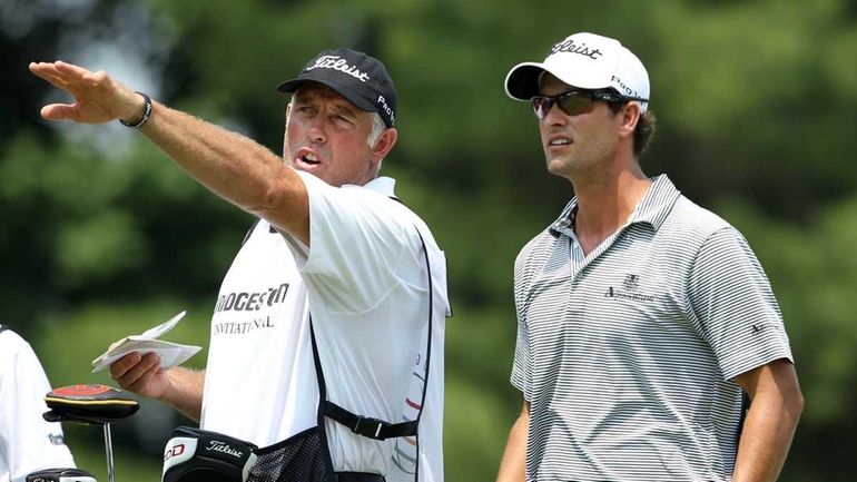 Adam Scott of Australia, right, talks with caddie Steve Williams,...