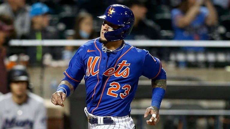 Javier Baez of the Mets scores a run in the fourth...