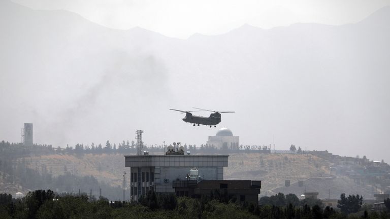 A U.S. Chinook helicopter flies over the U.S. embassy in...