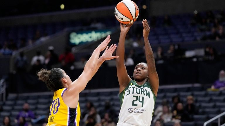 Seattle Storm guard Jewell Loyd, right, shoots as Los Angeles...