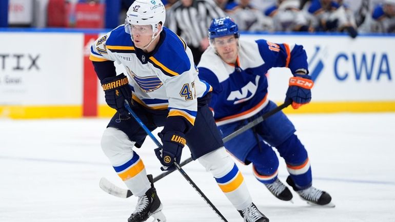 St. Louis Blues' Torey Krug (47) drives past New York...