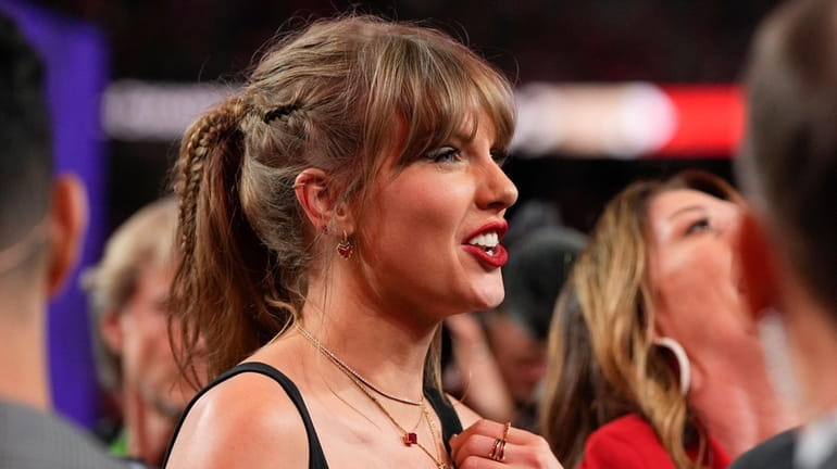 Taylor Swift watches the celebration on the field after the...