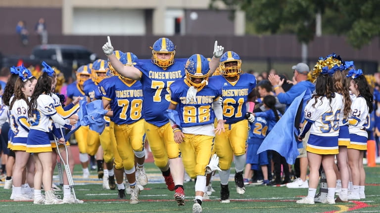 Comsewogue's football team takes the field on Oct. 23, 2021,...